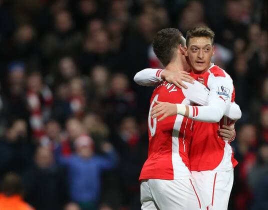 Arsenal s Laurent Koscielny celebrates scoring his sides opening goal with Mesut Ozil Barclays Premier League- Arsenal vs Leicester City - Emirates Stadium - England - 10th February 2015 - Picture David Klein Sportimage EDITORIAL USE ONLY. No use with unauthorised audio, video, data, fixture lists, club league logos or live services. Online in-match use limited to 120 images, no video emulation. No use in betting, games or single club league player publications.