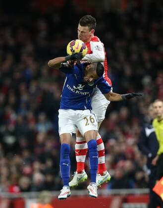 Arsenal s Lauren Koscielny catches Riyad Mahrez of Leicester with his elbow Barclays Premier League- Arsenal vs Leicester City - Emirates Stadium - England - 10th February 2015 - Picture David Klein Sportimage EDITORIAL USE ONLY. No use with unauthorised audio, video, data, fixture lists, club league logos or live services. Online in-match use limited to 120 images, no video emulation. No use in betting, games or single club league player publications.