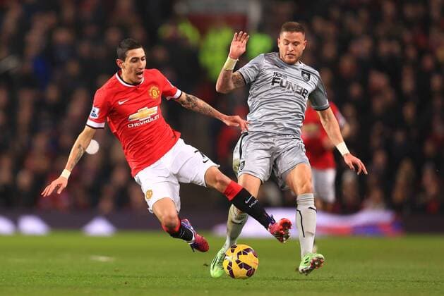 Michael Kightly of Burnley trips Angel di Maria of Manchester United ManU to earn a yellow card - Manchester United vs. Burnley - Barclay s Premier League - Old Trafford - Manchester - 11 02 2015 Pic Philip Oldham Sportimage EDITORIAL USE ONLY. No use with unauthorised audio, video, data, fixture lists, club league logos or live services. Online in-match use limited to 120 images, no video emulation. No use in betting, games or single club league player publications.