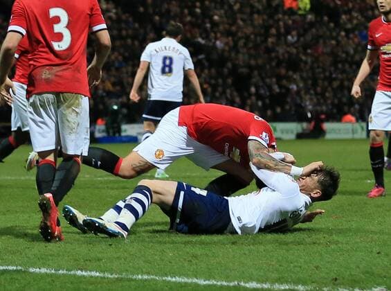 Preston s Joe Garner gets caught in the face off the ball by Manchester United ManU s Marcos Rojo FA Cup - Preston North End vs Manchester United - Deepdale - England - 16th February 2015 - Picture David Klein Sportimage EDITORIAL USE ONLY. No use with unauthorised audio, video, data, fixture lists, club league logos or live services. Online in-match use limited to 120 images, no video emulation. No use in betting, games or single club league player publications.