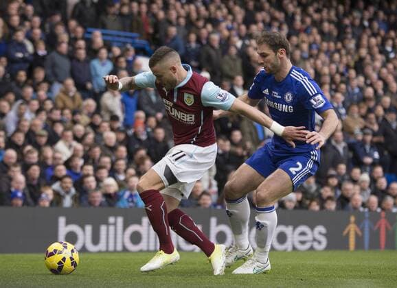 21.02.2015. London, England. Barclays Premier League. Chelsea versus Burnley. Burnley s Michael Kightly holds the ball up under pressure from Chelsea s Branislav Ivanovic. xNigelxCookex  ActionPlus11599184