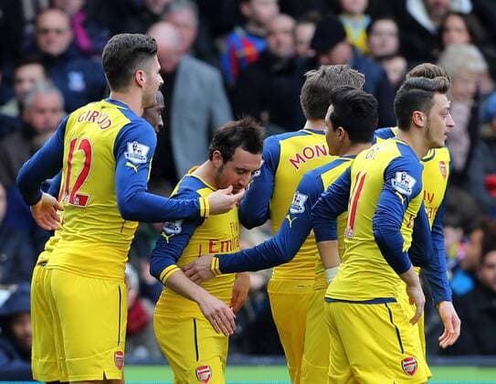 Arsenal s Santi Cazorla celebrates scoring his sides opening goal as Olivier Giroud holds his face Barclays Premier League - Crystal Palace vs Arsenal - Selhurst Park - England - 21st February 2015 - Picture David Klein Sportimage EDITORIAL USE ONLY. No use with unauthorised audio, video, data, fixture lists, club league logos or live services. Online in-match use limited to 120 images, no video emulation. No use in betting, games or single club league player publications.