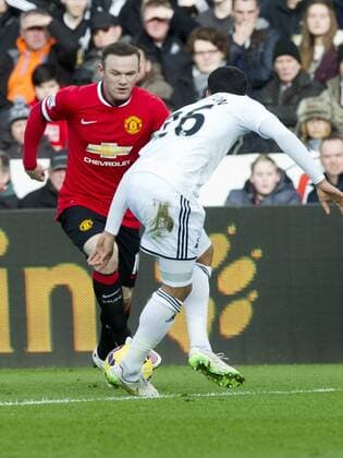 Football - 2014 2015 Premier League - Swansea City vs. Manchester United ManU Wayne Rooney captain of Manchester Utd attacks at the Liberty Stadium. COLORSPORT WINSTON BYNORTH 