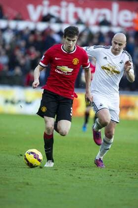Football - 2014 2015 Premier League - Swansea City vs. Manchester United ManU Paddy McNair of Manchester Utd attacks Jonjo Shelvey of Swansea at the Liberty Stadium. COLORSPORT WINSTON BYNORTH 