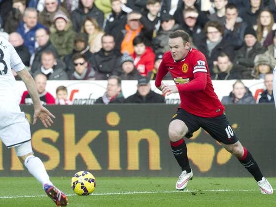 Football - 2014 2015 Premier League - Swansea City vs. Manchester United ManU Wayne Rooney captain of Manchester Utd attacks at the Liberty Stadium. COLORSPORT WINSTON BYNORTH 