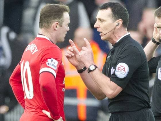 Football - 2014 2015 Premier League - Swansea City vs. Manchester United ManU Wayne Rooney captain of Manchester Utd speaks with refereee swarbrick after his team lose at the Liberty Stadium. COLORSPORT WINSTON BYNORTH 