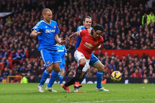 John O Shea of Sunderland pulls at Radamel Falcao of Manchester United ManU but Wes Brown is red carded - Manchester United (ManU) vs. AFC Sunderland - Barclay s Premier League - Old Trafford - Manchester - 28 02 2015 - EDITORIAL USE ONLY. No use with unauthorised audio, video, data, fixture lists, club league logos or live services. Online in-match use limited to 120 images, no video emulation. No use in betting, games or single club league player publications.