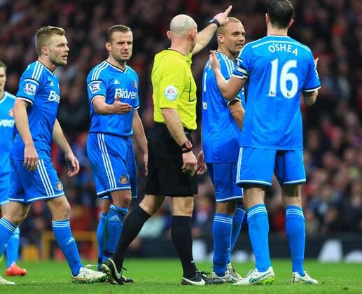The referee points Wes Brown of Sunderland in the direction of the changing rooms following his red card - Manchester United ManU vs. Sunderland - Barclay s Premier League - Old Trafford - Manchester - 28 02 2015 - EDITORIAL USE ONLY. No use with unauthorised audio, video, data, fixture lists, club league logos or live services. Online in-match use limited to 120 images, no video emulation. No use in betting, games or single club league player publications.