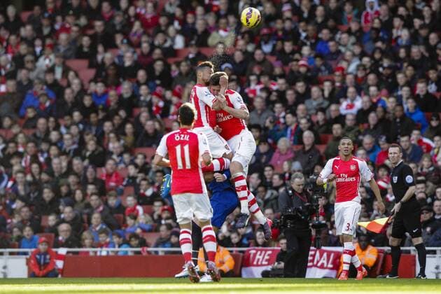 01.03.2015. London, England. Barclays Premier League. Arsenal versus Everton. Arsenal s Francis Coquelin (left) has a nasty clash of heads with Olivier Giroud &amp; has to receive extensive treatment on the pitch xCraigxMercerx  ActionPlus11601709