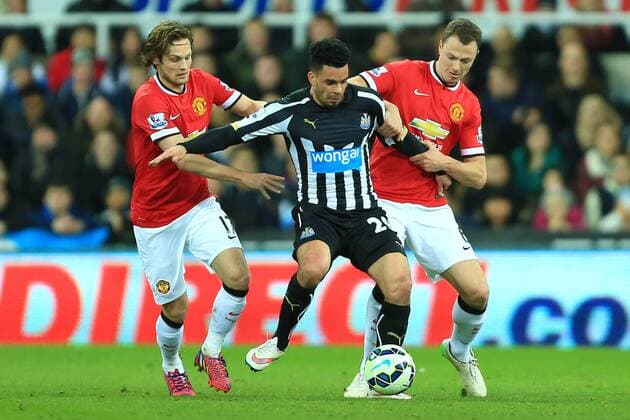 Daley Blind and Jonny Evans of Manchester United ManU get to grips with Emmanuel Riviere of Newcastle United - Newcastle United vs. Manchester United ManU - Barclay s Premier League - St James Park - Newcastle - 04 03 2015 Pic PhilipxOldham Sportimage EDITORIAL USE ONLY. No use with unauthorised audio, video, data, fixture lists, club league logos or live services. Online in-match use limited to 120 images, no video emulation. No use in betting, games or single club league player publications.