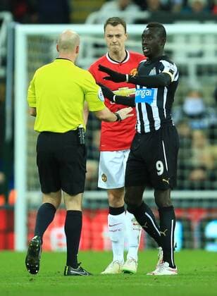 Jonny Evans of Manchester United ManU and Papiss Cisse of Newcastle United - Newcastle United vs. Manchester United - Barclay s Premier League - St James Park - Newcastle - 04 03 2015 Pic Philip Oldham Sportimage EDITORIAL USE ONLY. No use with unauthorised audio, video, data, fixture lists, club league logos or live services. Online in-match use limited to 120 images, no video emulation. No use in betting, games or single club league player publications.