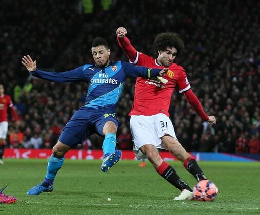Mauroane Fellaini of Manchester United ManU takes a shot on goal as Francis Coquelin of Arsenal closes him down - FA Cup Sixth Round - Manchester Utd vs Arsenal - Old Trafford Stadium - Manchester - England - 9th March 2015 - Picture Simon Bellis Sportimage EDITORIAL USE ONLY. No use with unauthorised audio, video, data, fixture lists, club league logos or live services. Online in-match use limited to 120 images, no video emulation. No use in betting, games or single club league player publications.