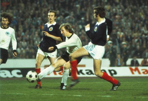 Football - 1973 1974 International Friendly Länderspiel - West Germany 2 Scotland 1 Scotland s Eric Schaedler, playing in his first and only international, fails to stop Jurgen Grabowski scoring for Germany at the Waldstadion, Frankfurt. Scotland s Tommy Hutchison is behind. 27 03 1974 