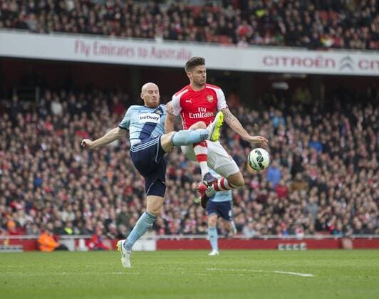 14.03.2015. London, England. Barclays Premier League. Arsenal versus West Ham. West Ham United s James Collins gets the challenge in on Arsenal s Olivier Giroud. xNigelxCookex  ActionPlus11604760