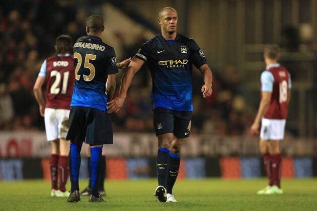 Fernandinho and Vincent Kompany of Manchester City exchange supportive touches - Burnley vs. Manchester City - Barclay s Premier League - Turf Moor - Burnley - 14 03 2015 Pic Philip Oldham Sportimage EDITORIAL USE ONLY. No use with unauthorised audio, video, data, fixture lists, club league logos or live services. Online in-match use limited to 120 images, no video emulation. No use in betting, games or single club league player publications.