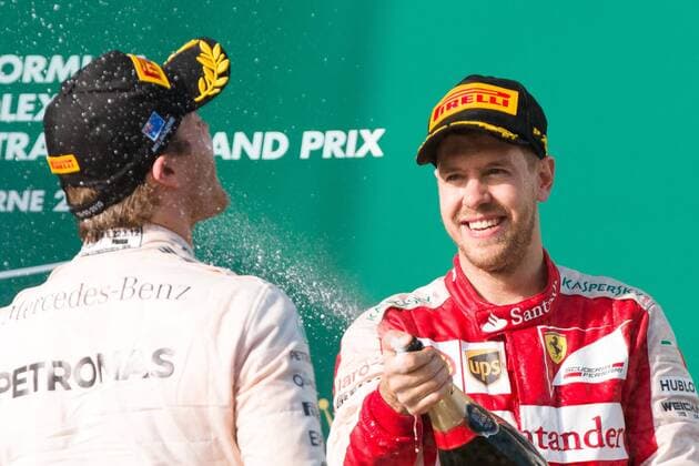 March 15, 2015: Nico Rosberg (DEU) 6 (2nd) and Sebastian Vettel (DEU) 5 (3rd) spray champagne on the podium at the 2015 Australian Formula One Grand Prix at Albert Park, Melbourne, Australia. Sydney Low Cal Media Formula One 2015: Australia MAR 15 - ZUMAc04_