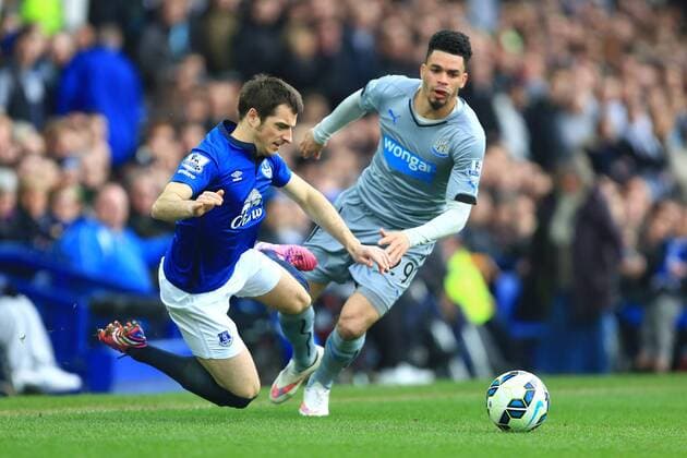 Leighton Baines of Everton is tripped by Emmanuel Riviere of Newcastle United - Everton vs. Newcastle United - Barclay s Premier League - Goodison Park - Liverpool - 15 03 2015 Pic Philip Oldham Sportimage EDITORIAL USE ONLY. No use with unauthorised audio, video, data, fixture lists, club league logos or live services. Online in-match use limited to 120 images, no video emulation. No use in betting, games or single club league player publications.