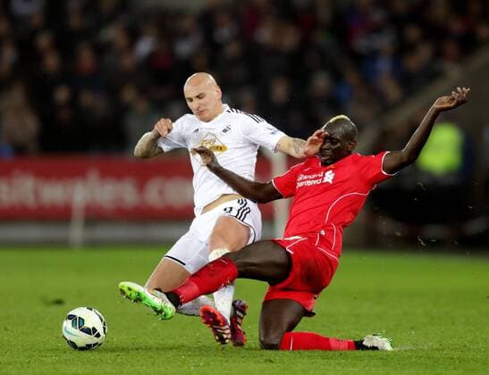 Mamadou Sakho of Liverpool challenges Jonjo Shelvey of Swansea City - Barclays Premier League - Swansea City vs Liverpool - Liberty Stadium - Swansea - Wales - 16th March 2015 - Picture Simon Bellis Sportimage EDITORIAL USE ONLY. No use with unauthorised audio, video, data, fixture lists, club league logos or live services. Online in-match use limited to 120 images, no video emulation. No use in betting, games or single club league player publications.