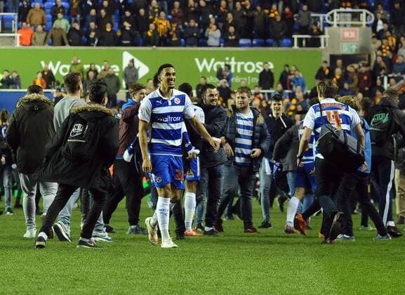 Football - 2014 2015 FA Cup - Sixth Round, Replay: Reading s Nick Blackman leaves the field as fans invade the pitch after the match at the Madjeski Stadium. COLORSPORT ANDREW COWIE 
