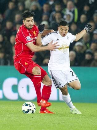Football - 2014 2015 Premier League - Swansea City vs. LIVERPOOL Liverpool Midfielder Emre Can & Jefferson Montero of Swansea at the Liberty Stadium. Â© winston bynorth COLORSPORT WINSTON BYNORTH 