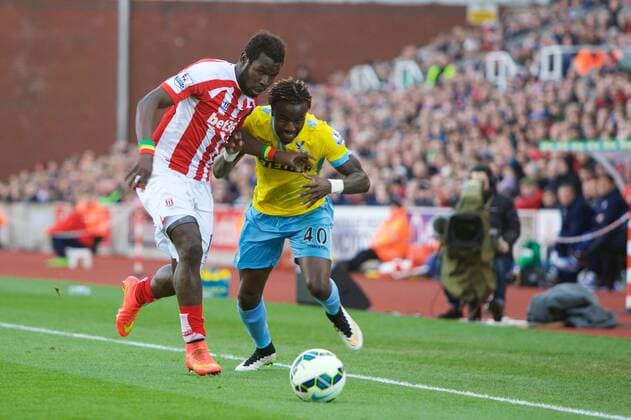 21.03.2015. Stoke, England. Barclays Premier League. Stoke City versus Crystal Palace. Stoke City forward Mame Biram Diouf and Crystal Palace defender Pape Souare fight for the ball. xTimxWilliamsx  ActionPlus11606955