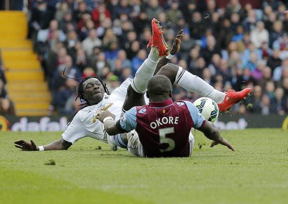 Bafetimi Gomis of Swansea competes with Jores Okore of Aston Villa Football - Barclays Premier League - Aston Villa vs Swansea City - Villa Park Birmingham - Season 2014 15 - 21st March 2015 - Photo Malcolm Couzens Sportimage EDITORIAL USE ONLY. No use with unauthorised audio, video, data, fixture lists, club league logos or live services. Online in-match use limited to 120 images, no video emulation. No use in betting, games or single club league player publications.