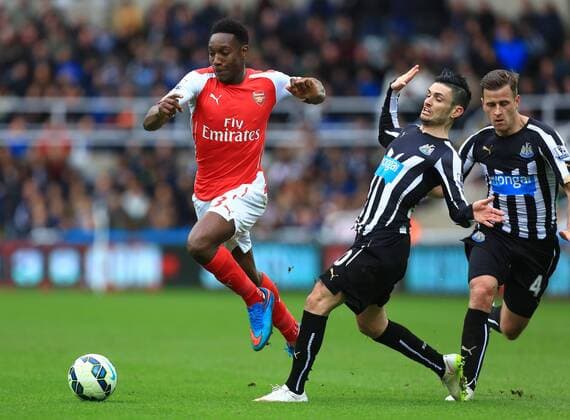 Arsenal s Danny Welbeck skips past a challenge by Remy Cabella of Newcastle United - Newcastle United vs. Arsenal - Barclay s Premier League - St James Park - Newcastle - 21 03 2015 Pic Philip Oldham Sportimage EDITORIAL USE ONLY. No use with unauthorised audio, video, data, fixture lists, club league logos or live services. Online in-match use limited to 120 images, no video emulation. No use in betting, games or single club league player publications.