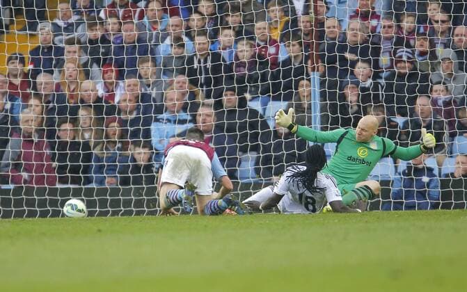 Befatimi Gomis of Swansea scores the first goal of the game past Villa goalkeeper Brad Guzan - Football - Barclays Premier League - Aston Villa vs Swansea City - Villa Park Birmingham - Season 2014 15 - 21st March 2015 - Photo Malcolm Couzens Sportimage EDITORIAL USE ONLY. No use with unauthorised audio, video, data, fixture lists, club league logos or live services. Online in-match use limited to 120 images, no video emulation. No use in betting, games or single club league player publications.