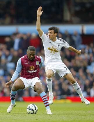 Charles N Zogbia of Aston Villa competes with Jack Cork of Swansea - Football - Barclays Premier League - Aston Villa vs Swansea City - Villa Park Birmingham - Season 2014 15 - 21st March 2015 - Photo Malcolm Couzens Sportimage EDITORIAL USE ONLY. No use with unauthorised audio, video, data, fixture lists, club league logos or live services. Online in-match use limited to 120 images, no video emulation. No use in betting, games or single club league player publications.