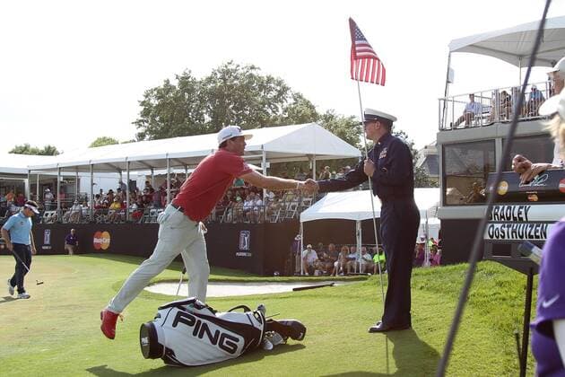 March 22, 2015 - Orlando, Florida, United States - Keegan Bradley (L) shakes hands with a flag bearer on the 17th green during the final round of the Arnold Palmer Invitational presented by MasterCard at Bay Hill Club & Lodge. Golf 2015 - Matt Every Wins Arnold Palmer Invitational - ZUMAw109