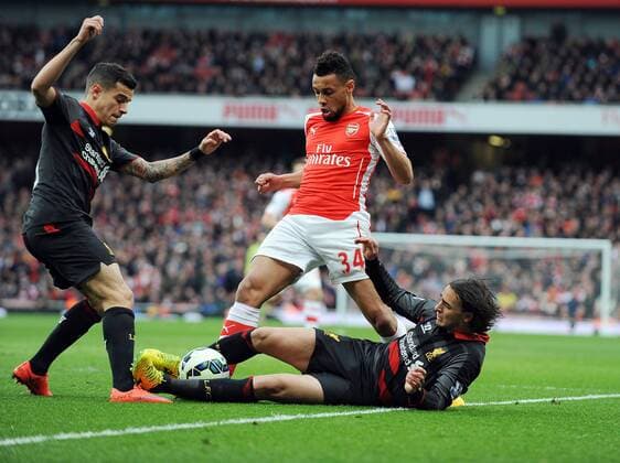 Aktuell Fußball, England, Premier League, FC Arsenal - FC Liverpool Francis Coquelin of Arsenal is challenged by Lazar Markovic of Liverpool Barclays Premier League Arsenal vs Liverpool Emirates Stadium London England 4th April 2015 Pic Robin Parker Sportimage EDITORIAL USE ONLY. No use with unauthorised audio, video, data, fixture lists, club league logos or live services. Online in-match use limited to 120 images, no video emulation. No use in betting, games or single club league player publications. DSC_1200.JPG