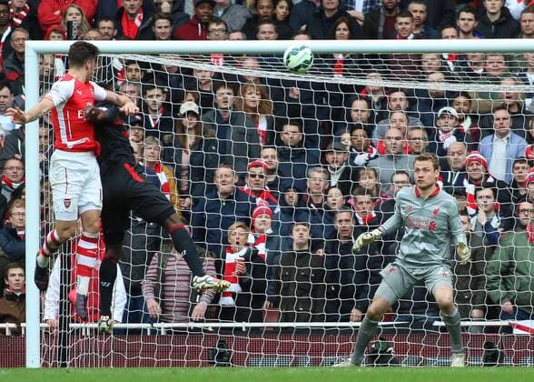 Football - 2014 2015 - Barclays Premier League, - Arsenal Vs Liverpool, Arsenal s Olivier Giroud rises highest to head at goal at The Emirates Stadium COLORSPORT DANIEL BEARHAM  ARS_LIV