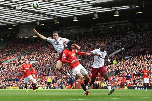 Ciaran Clark of Aston Villa defends against Marouane Fellaini of Manchester United ManU - Manchester United vs. Aston Villa - Barclay s Premier League - Old Trafford - Manchester - 04 04 2015 Pic Philip Oldham Sportimage EDITORIAL USE ONLY. No use with unauthorised audio, video, data, fixture lists, club league logos or live services. Online in-match use limited to 120 images, no video emulation. No use in betting, games or single club league player publications.