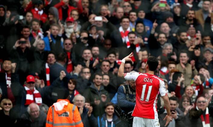Ozil of Arsenal celebrates his goal during the Barclays Premier League match between Arsenal and Liverpool at the Emirates Stadium in London, England on April 4, 2015. Arsenal won 4-1. ) FOR EDITORIAL USE ONLY. NOT FOR SALE FOR MARKETING OR ADVERTISING CAMPAIGNS. NO USE WITH UNAUTHORIZED AUDIO, VIDEO, DATA, FIXTURE LISTS, CLUB LEAGUE LOGOS OR LIVE SERVICES. ONLINE IN-MATCH USE LIMITED TO 45 IMAGES, NO VIDEO EMULATION. NO USE IN BETTING, GAMES OR SINGLE CLUB LEAGUE PLAYER PUBLICATIONS.? (SP)UK-LONDON-SOCCER-BARCLAYS PREMIER LEAGUE-ARSENAL VS LIVERPOOL HanxYan 