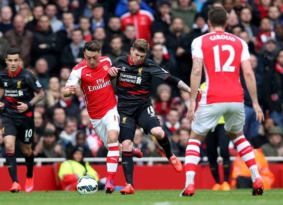 Ozil of Arsenal (2nd L) breaks through during the Barclays Premier League match between Arsenal and Liverpool at the Emirates Stadium in London, England on April 4, 2015. Arsenal won 4-1. ) FOR EDITORIAL USE ONLY. NOT FOR SALE FOR MARKETING OR ADVERTISING CAMPAIGNS. NO USE WITH UNAUTHORIZED AUDIO, VIDEO, DATA, FIXTURE LISTS, CLUB LEAGUE LOGOS OR LIVE SERVICES. ONLINE IN-MATCH USE LIMITED TO 45 IMAGES, NO VIDEO EMULATION. NO USE IN BETTING, GAMES OR SINGLE CLUB LEAGUE PLAYER PUBLICATIONS.? (SP)UK-LONDON-SOCCER-BARCLAYS PREMIER LEAGUE-ARSENAL VS LIVERPOOL HanxYan 