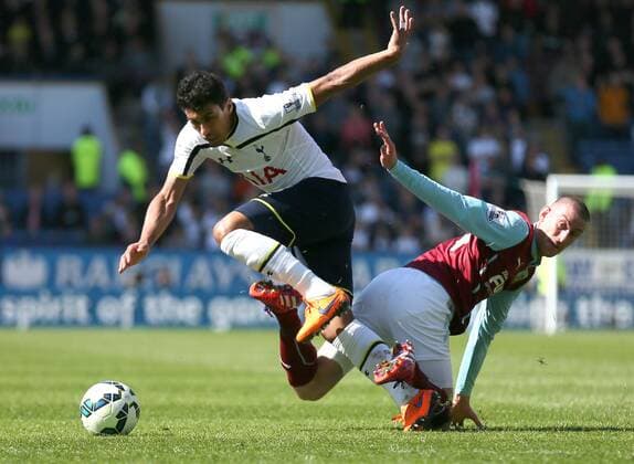 Paulinho of Tottenham tackled by David Jones of Burnley - Barclays Premier League - Burnley vs Tottenham - Turf Moor Stadium - Burnley - England - 5th April 2015 - Picture Simon Bellis Sportimage EDITORIAL USE ONLY. No use with unauthorised audio, video, data, fixture lists, club league logos or live services. Online in-match use limited to 120 images, no video emulation. No use in betting, games or single club league player publications.
