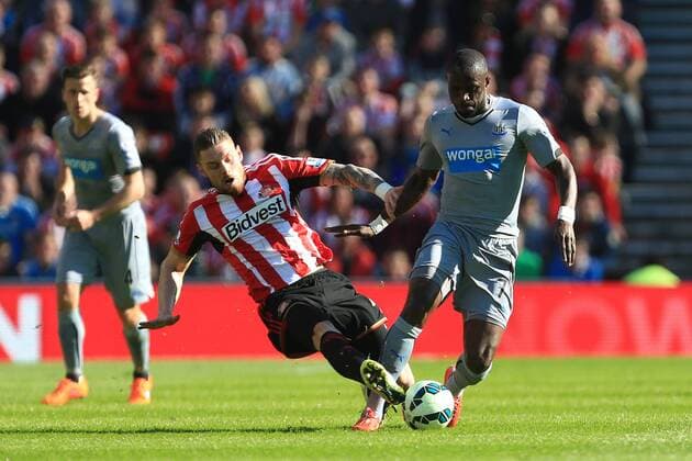 Connor Wickham of Sunderland tackles Moussa Sissoko of Newcastle United - Sunderland vs. Newcastle United - Barclay s Premier League - Stadium of Light - Sunderland - 05 04 2015 Pic Philip Oldham Sportimage EDITORIAL USE ONLY. No use with unauthorised audio, video, data, fixture lists, club league logos or live services. Online in-match use limited to 120 images, no video emulation. No use in betting, games or single club league player publications.