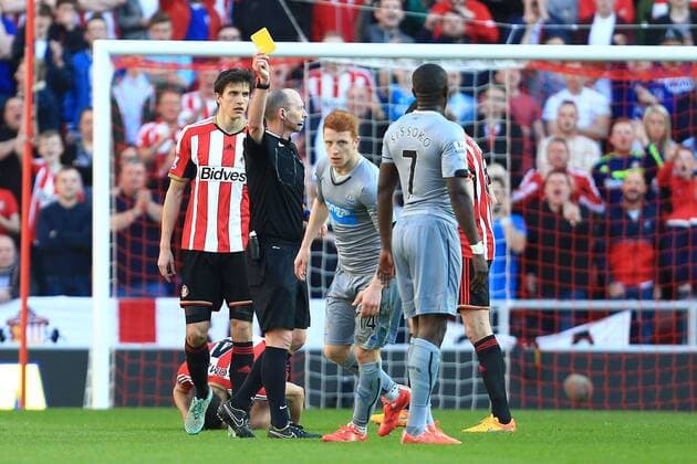 Referee Mike Dean shows Jack Colback of Newcastle United a yellow card - Sunderland vs. Newcastle United - Barclay s Premier League - Stadium of Light - Sunderland - 05 04 2015 Pic Philip Oldham Sportimage EDITORIAL USE ONLY. No use with unauthorised audio, video, data, fixture lists, club league logos or live services. Online in-match use limited to 120 images, no video emulation. No use in betting, games or single club league player publications.