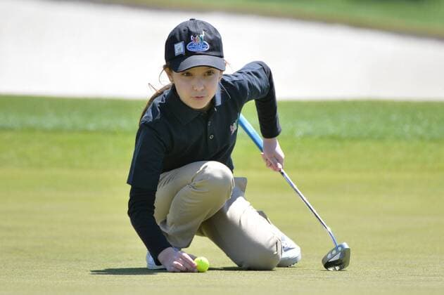 Effie Perakis, of Glenview, Illinois, lines up a putt during the 7-9 girls division of the Drive, Chip and Putt National Finals during Masters week at Augusta, National in Augusta, Georgia on April 5, 2015.  WAP20150405311 KEVINxDIETSCH