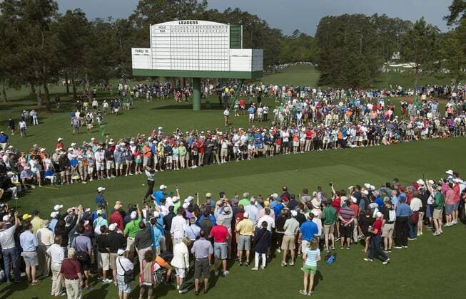 Patrons gather as Rory McIlroy hits off of the eighth tee during a practice round prior to the 2015 Masters Tournament at Augusta, National in Augusta, Georgia on April 6, 2015. The Masters will start on Thursday, April 9.  AUG20150406312 KEVINxDIETSCH