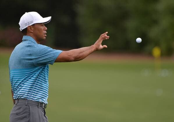 Tiger Woods catches a ball on the practice range during a practice round prior to the 2015 Masters Tournament at Augusta, National in Augusta, Georgia on April 6, 2015.  AUG20150406331 KEVINxDIETSCH