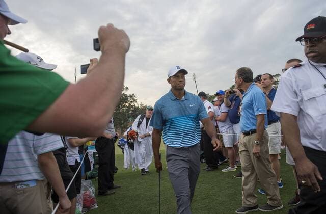 Tiger Woods walks off the 9th green during a practice round prior to the 2015 Masters Tournament at Augusta, National in Augusta, Georgia on April 6, 2015.  AUG20150406341 KEVINxDIETSCH