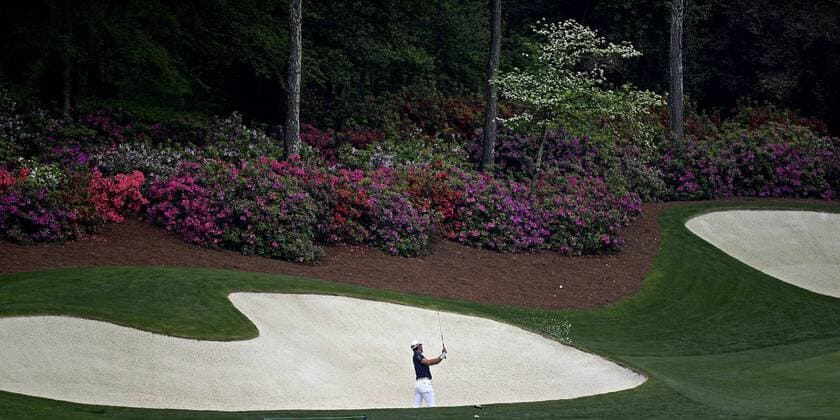 April 7, 2015 - Augusta, GA, USA - The azaleas and a dogwood begin to display their blooms as golfer Mike Weir hits from a bunker along the 13th green on Tuesday, April 7, 2015 at Augusta National Golf Club in Augusta, Ga. Masters practice - ZUMAm67_