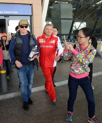 Finnish F1 driver Kimi Raikkonen of Ferrari, left, is pictured after arriving at the Shanghai Pudong International Airport in Shanghai, China, 9 April 2015. Kimi Raikkonen receives warm welcome in Shanghai  pbu256432_23