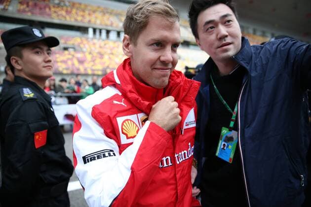 German F1 driver Sebastian Vettel of Ferrari, center, is pictured at the Shanghai International Circuit before the 2015 Formula 1 Chinese Grand Prix in Shanghai, China, 9 April 2015. F1 drivers wow fans with signatures and selfies in Shanghai  20150409_10245