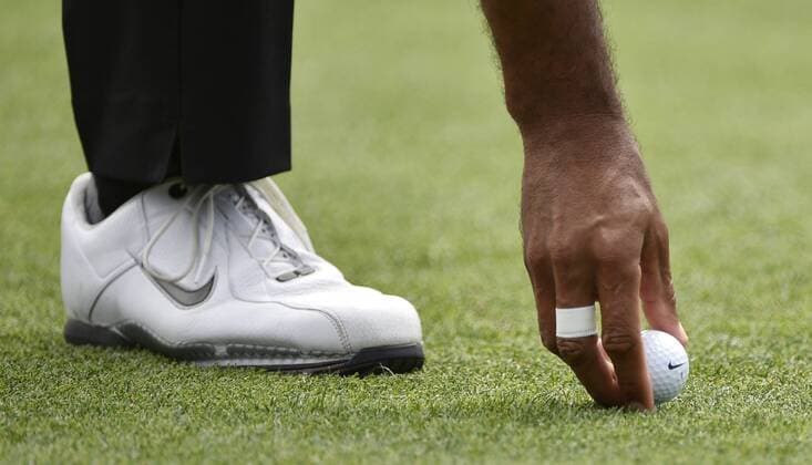 Tiger Woods tees up his Nike golf ball on the 1st hole tee box in the third round of the 2015 Masters Tournament at Augusta National Golf Club in Augusta, Georgia on April 11, 2015.  AUG20150411106 KEVINxDIETSCH