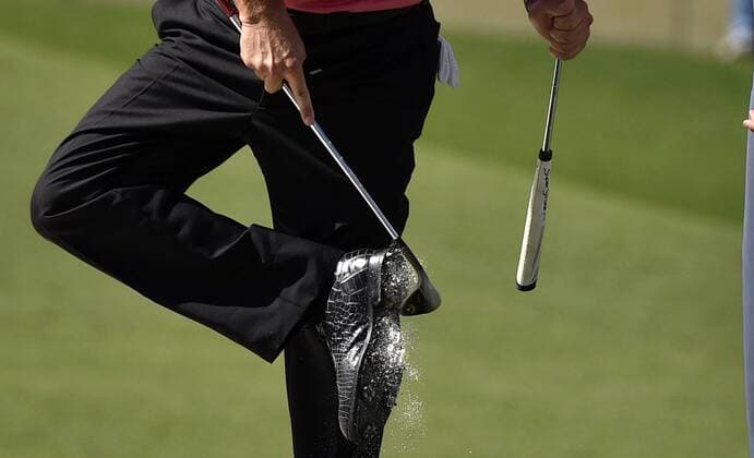 Phil Mickelson taps sand out of his spikes around the 7th green in the third round of the 2015 Masters Tournament at Augusta National Golf Club in Augusta, Georgia on April 11, 2015.  AUG20150411125 KEVINxDIETSCH