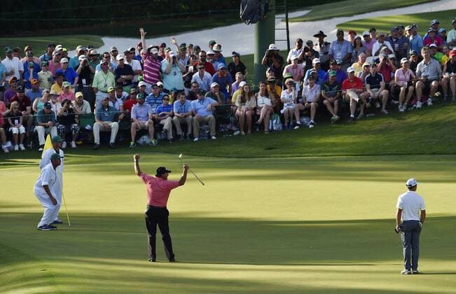 Patrons celebrate with Phil Mickelson after he makes a long putt for birdie on the 16th hole in the third round of the 2015 Masters Tournament at Augusta National Golf Club in Augusta, Georgia on April 11, 2015.  AUG20150411132 KEVINxDIETSCH