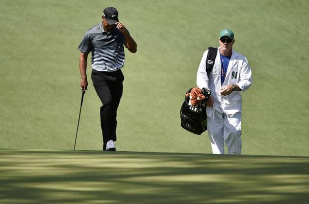 Tiger Woods and caddie Joe LaCava walk to the 10th green in the third round of the 2015 Masters Tournament at Augusta National Golf Club in Augusta, Georgia on April 11, 2015.  AUG20150411127 KEVINxDIETSCH