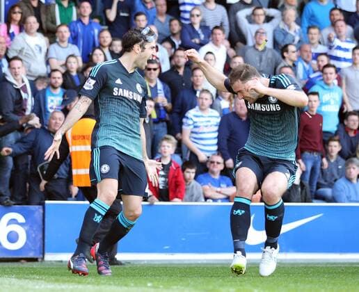 Chelsea s Cesc Fabregas celebrates scoring his sides opening goal as Branislav Ivanovic gets hit by a coin Barclays Premier League- Queens Park Rangers vs Chelsea - Loftus Road - England - 12h April 2015 - Picture David Klein Sportimage EDITORIAL USE ONLY. No use with unauthorised audio, video, data, fixture lists, club league logos or live services. Online in-match use limited to 120 images, no video emulation. No use in betting, games or single club league player publications.
